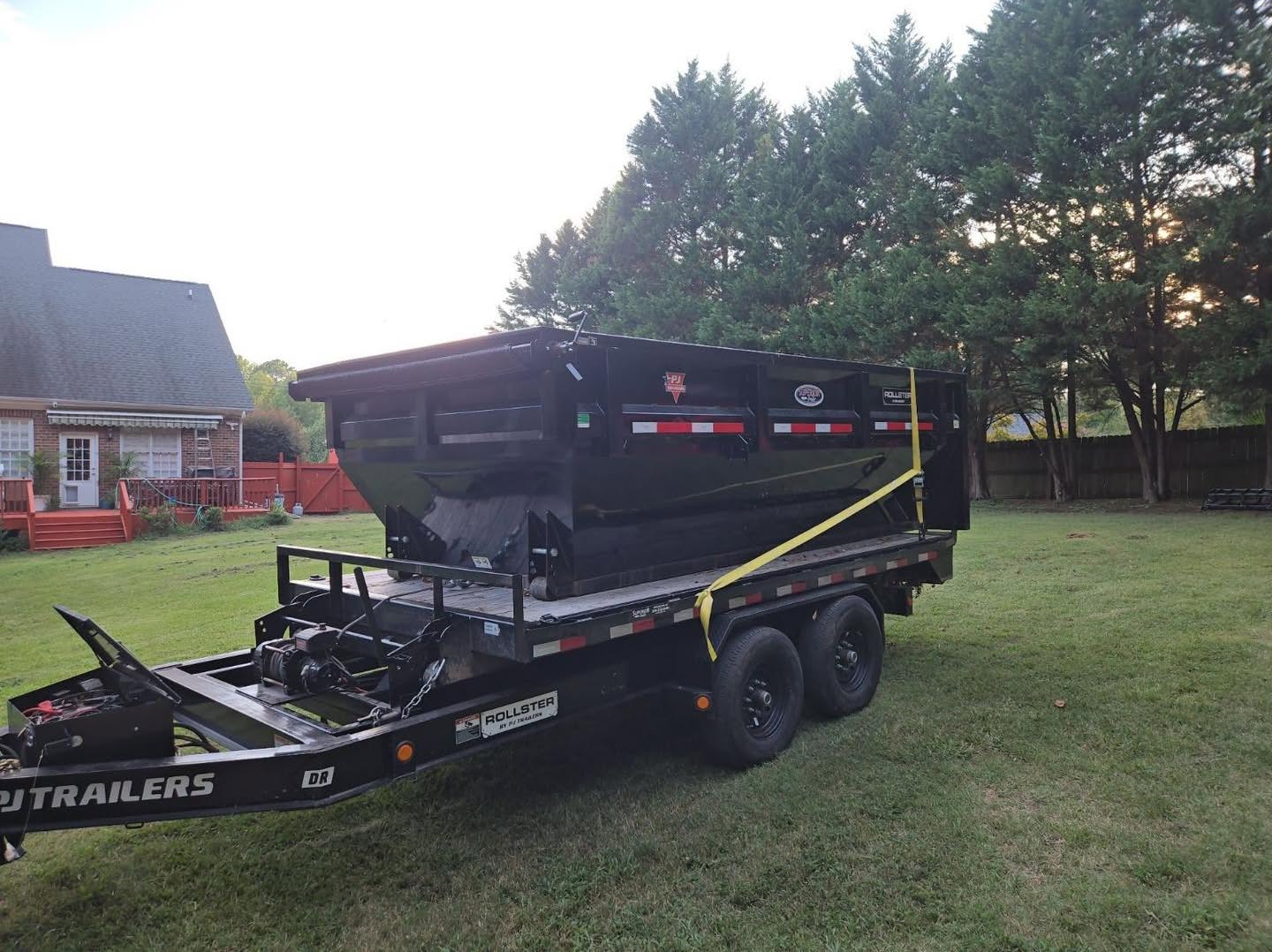 Roll off dumpster on a residential driveway ready for loading