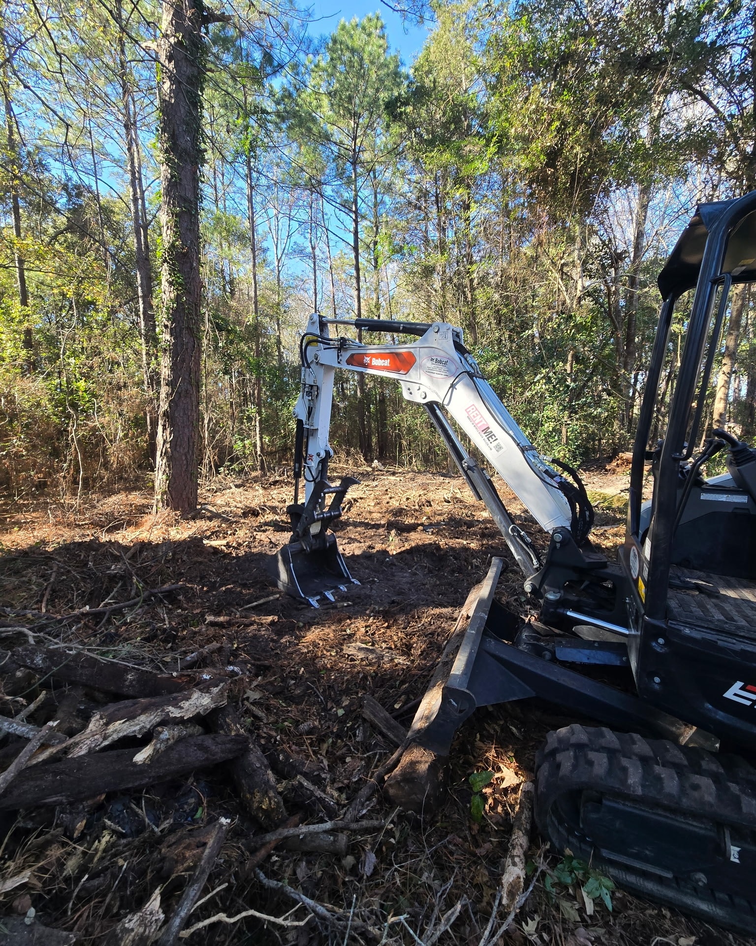 Yellow excavator digging on a construction or landscaping site